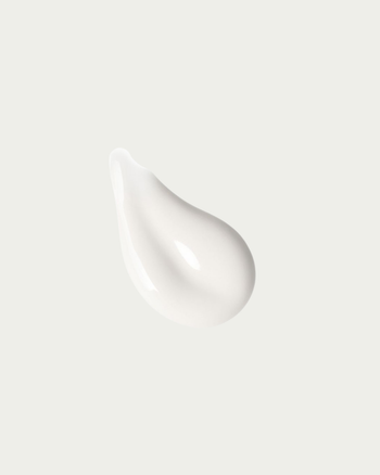 White cream droplet on a light gray background