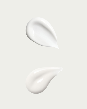 Two white cream swatches on a light gray background