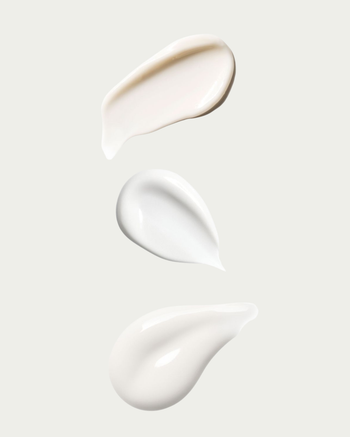 Three texture swatches of white cream on a light gray background