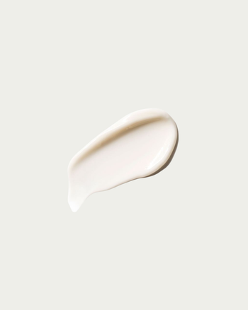 White cream smear on a light gray background